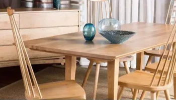 DS11 - Coordinated warm wooden dining table set with spindle-backed chairs in front of wooden buffet