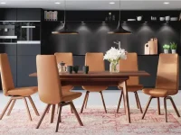 DS13 - Caramel-colored upholstered dining chairs with slender wooden legs in a contemporary style