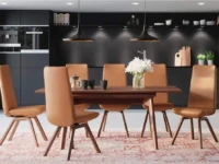 DS13 - Caramel-colored upholstered dining chairs with slender wooden legs in a contemporary style