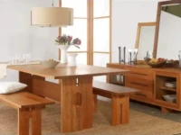 DS15 - Solid wood dining table flanked by sturdy benches over natural fiber rug adjacent to matching spacious sideboard