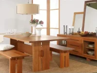 DS15 - Solid wood dining table flanked by sturdy benches over natural fiber rug adjacent to matching spacious sideboard