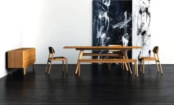 DS4 - A mid-century modern dining set with a smooth bamboo honey-toned wooden table and chairs on a dark hardwood floor