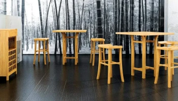 DS7 - Natural bamboo wine rack stools and tables set against a backdrop of a monochrome forest mural