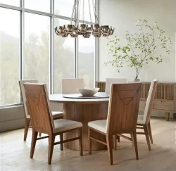 DS9 - Circular wood tabletop with angular wooden chairs under a modern chandelier beside a large window
