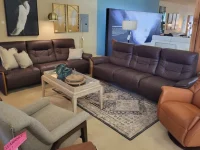 Brown leather sofas tan leather chair artwork and designer lamp