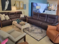 Brown leather sofas tan leather chair artwork and designer lamp