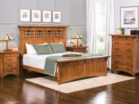 Arts and Crafts bedroom set in quarter sawn oak featuring lattice headboard bed matching nightstands and chest with craftsman lamps and colorful gallery wall