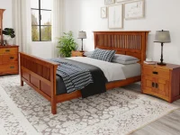 Arts and Crafts mission bedroom collection with slatted headboard bed dresser and nightstands in cherry finish paired with plaid bedding and botanical art