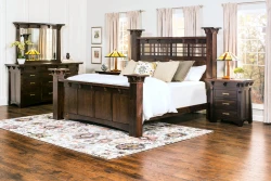 Bedroom collection in dark oak featuring four poster bed dresser and nightstands with Mission style lamps floral rug and craftsman stained glas