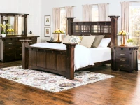 Bedroom collection in dark oak featuring four poster bed dresser and nightstands with Mission style lamps floral rug and craftsman stained glas