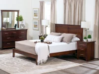 Contemporary Shaker panel bed in dark cherry featuring clean lines dresser with mirror nightstands and swing arm lamps with geometric pattern rug