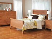 Contemporary Shaker panel bed set in natural maple featuring clean lines dresser with mirror and tapered leg nightstands with yellow floral bedding
