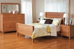 Contemporary Shaker panel bed set in natural maple featuring clean lines dresser with mirror and tapered leg nightstands with yellow floral bedding