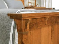 Craftsman style bed detail highlighting solid wood construction decorative corbels layered crown molding and traditional joinery in warm oak finish