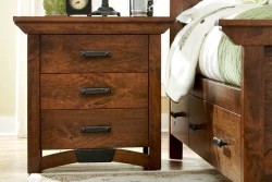 Craftsman style nightstand in rustic brown maple with black iron pulls curved base detail and three spacious drawers with dovetail construction