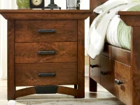 Craftsman style nightstand in rustic brown maple with black iron pulls curved base detail and three spacious drawers with dovetail construction