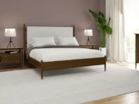 Mid century modern bedroom set with walnut frame upholstered headboard matching nightstands and dresser featuring tripod lamps and tropical plant accent