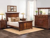 Mission style bedroom suite in brown oak featuring panel bed matching nightstands and dresser with table lamps and stained glass wall art