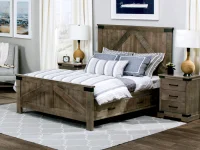 Modern farmhouse bedroom set with weathered gray barn door bed matching nightstands and storage drawers featuring nautical artwork and woven rattan lamps