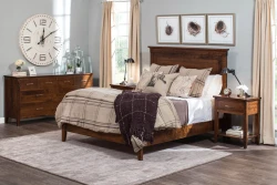 Modern farmhouse panel bed set in rustic brown maple featuring tapered leg dresser nightstands with industrial lamps birds nest artwork and plaid bedding