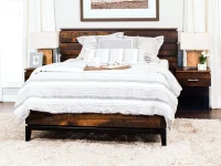 Modern industrial platform bed in reclaimed wood featuring horizontal planked headboard attached nightstands with metal base and striped linen bedding