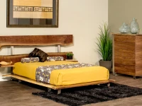 Modern organic platform bed in natural walnut featuring live edge headboard slats with metal supports white bedding and yellow floral accent pillows