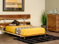 Modern organic platform bed in natural walnut featuring live edge headboard slats with metal supports white bedding and yellow floral accent pillows