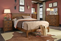 Rustic craftsman bedroom set with planked headboard bed and coordinating case pieces in distressed oak featuring antler decor and botanical prints