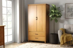 Scandinavian modern wardrobe armoire in light oak finish with dual doors two storage drawers black handles beside fiddle leaf fig plant and gray sofa