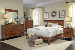 Traditional wood bedroom collection with panel bed dresser and nightstands in warm brown finish complemented by cream walls botanical prints and sunburst mirror
