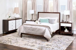 Transitional bedroom collection featuring dark wood frame upholstered panel bed white drawer dresser nightstand set with brushed nickel hardware and floral rug