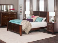 Transitional bedroom set with panel bed dresser and nightstands in rich brown finish featuring teal accents gray curtains and contemporary table lamps