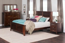 Transitional bedroom set with panel bed dresser and nightstands in rich brown finish featuring teal accents gray curtains and contemporary table lamps