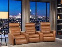 Tan leather three-seat H2 Seating power reclining sofa with tufted backrests, plush armrests, and built-in footrests, featuring two central consoles with cup holders and storage