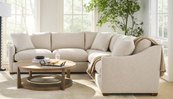 Rowe - Beige Sectional Sofa With Plush Cushions Near Large Windows And Plant, With Wooden Coffee Table, Home Decor