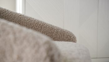 Rowe - Beige Shaggy Armchair With Plush Upholstery Near White Geometric Ribbed Panel Doors Home Decor