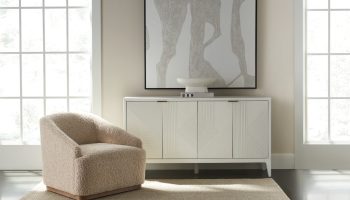 Rowe - Beige Shaggy Armchair With Wooden Base Near White Console Table With Geometric Ribbed Panel Doors Under Abstract Art Home Decor