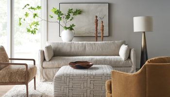 Rowe - Beige Slipcover Sofa With Patterned Ottoman And Brown Armchairs In Modern Living Room With Home Decor