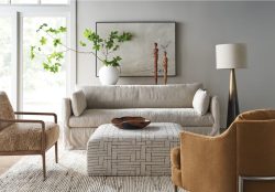 Rowe - Beige Slipcover Sofa With Patterned Ottoman And Brown Armchairs In Modern Living Room With Home Decor