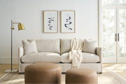 Rowe - Beige Sofa With Plush Cushions And Throw Blanket, Two Brown Ottomans, Under Wall Art, Home Decor
