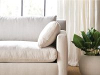 Rowe - Beige Sofa With Plush Cushions Near Large Window With White Curtains And Potted Plant Home Decor