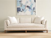 Rowe - Beige Sofa With White Pillows Under Abstract Painting On Neutral Wall, On Woven Rug, Home Decor