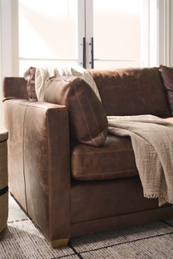 Rowe - Brown Leather Sofa With Plush Cushions And Throw Blanket Near Large Window