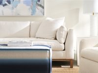 Rowe - Cream Sofa With Plush Cushions Near White Lamp And Ottoman Under Abstract Art Home Decor