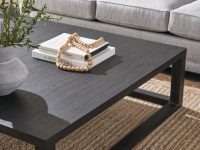 Rowe - Dark Wood Coffee Table With Books And Decor On Woven Rug Near Grey Sofa With Blue Pillow