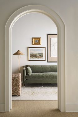 Rowe - Green Velvet Sofa With Plush Cushions Under Framed Artwork Near Patterned Lamp And Console Table