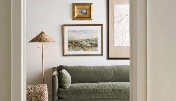 Rowe - Green Velvet Sofa With Plush Cushions Under Framed Artwork Near Patterned Lamp And Console Table