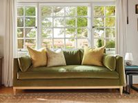 Rowe - Green Velvet Sofa With Yellow And White Pillows Under Large Window Near Wooden Side Table