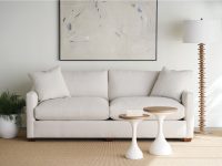 Rowe - Light Gray Sofa With Plush Cushions Near Two White Nesting Tables Under Abstract Art