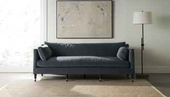 Rowe - Navy Blue Sofa With Plush Cushions On Beige Rug Under Abstract Art Near Floor Lamp